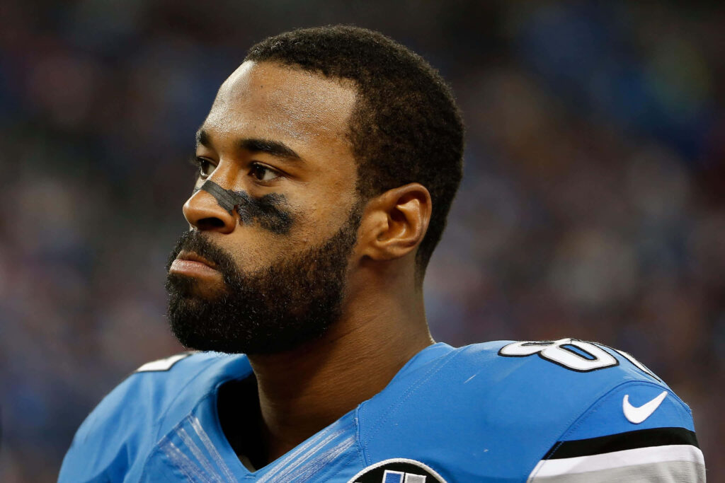 Close-up of Calvin Johnson in Detroit Lions uniform with eye black focused intense sports portrait Wallpaper