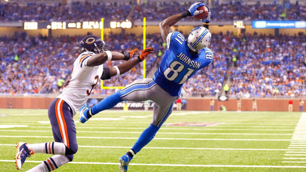 Calvin Johnson Detroit Lions leaping catch mid-air in vibrant football action against Bears Wallpaper