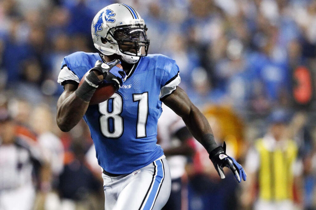 Calvin Johnson Detroit Lions wide receiver sprinting in blue number 81 jersey stadium background Wallpaper