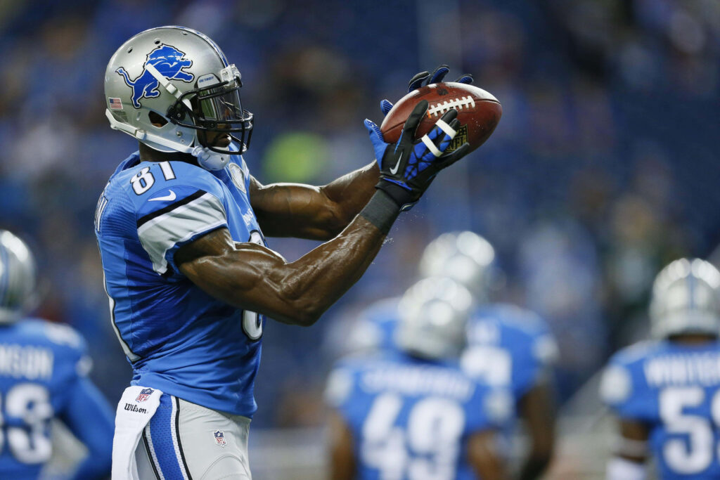 Calvin Johnson Detroit Lions catching football in blue silver uniform dynamic game action wallpaper