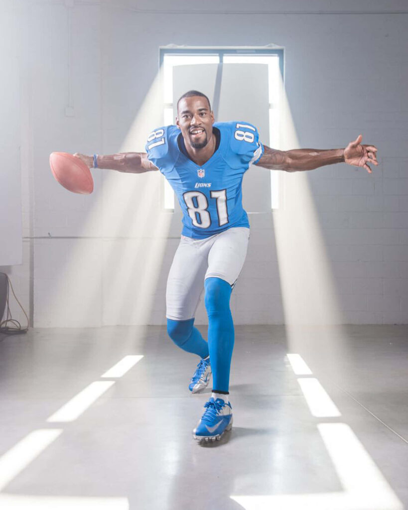 Calvin Johnson Detroit Lions wallpaper action pose with football bright light minimalist background