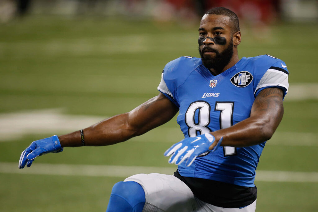 Calvin Johnson Detroit Lions wallpaper mid-action vibrant blue silver football stadium background