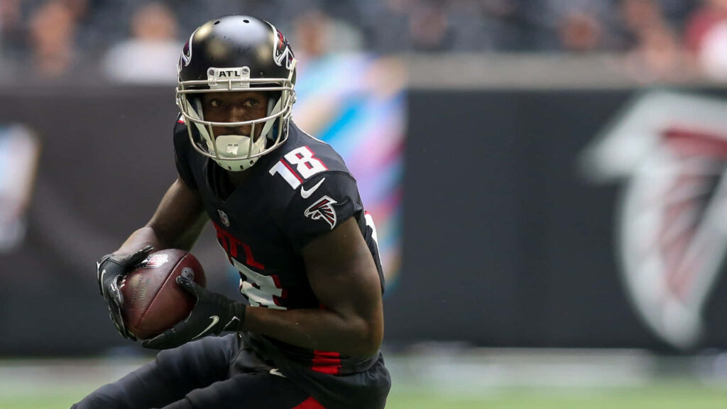 Calvin Ridley Atlanta Falcons intense action football play black red uniform dynamic wallpaper