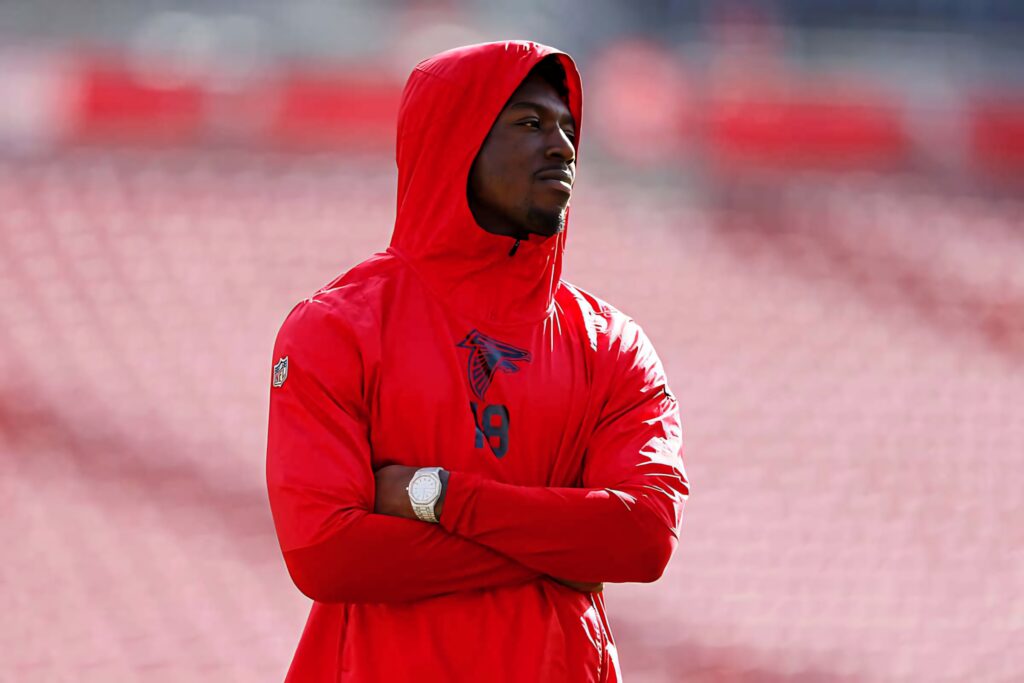 Calvin Ridley in red Atlanta Falcons hoodie with focused expression stadium background wallpaper