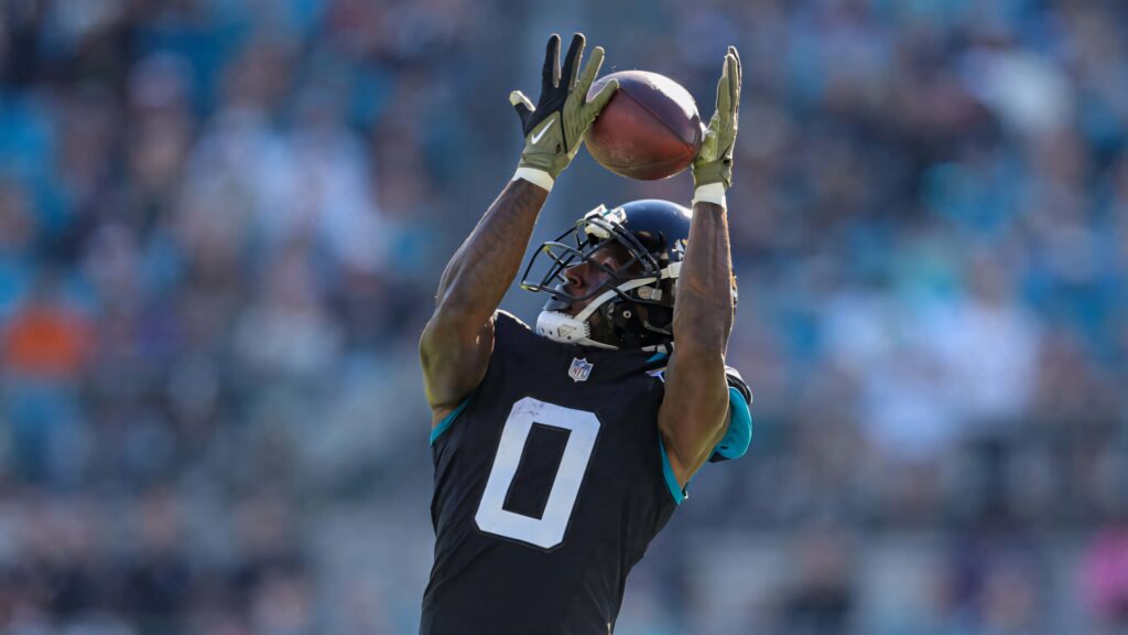 Calvin Ridley catching football in black uniform number 0 during intense game action wallpaper