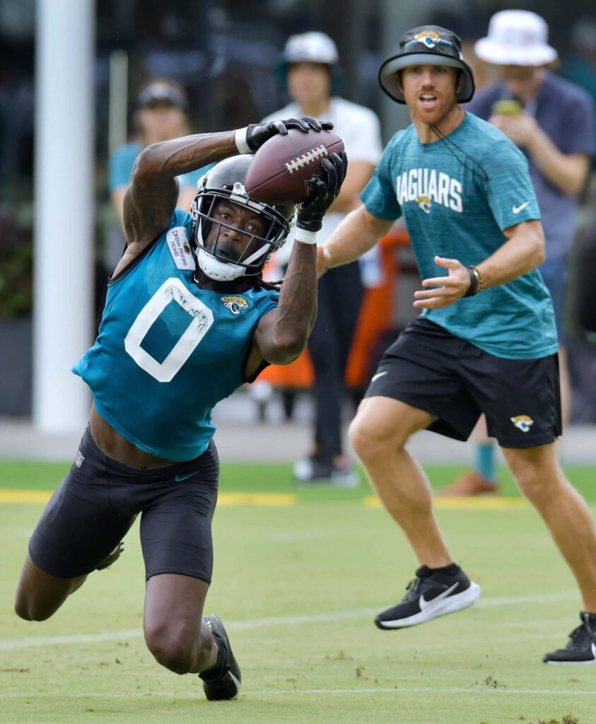 Calvin Ridley diving catch during football practice in Jaguars uniform dynamic action shot Wallpaper