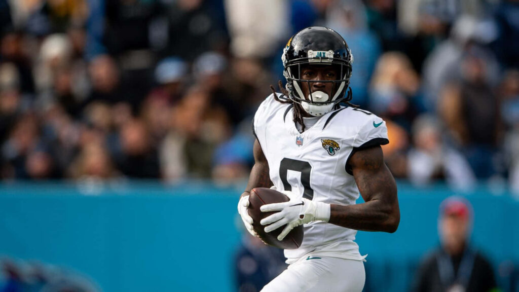 Calvin Ridley running with the ball for Jacksonville Jaguars in vibrant football game action wallpaper
