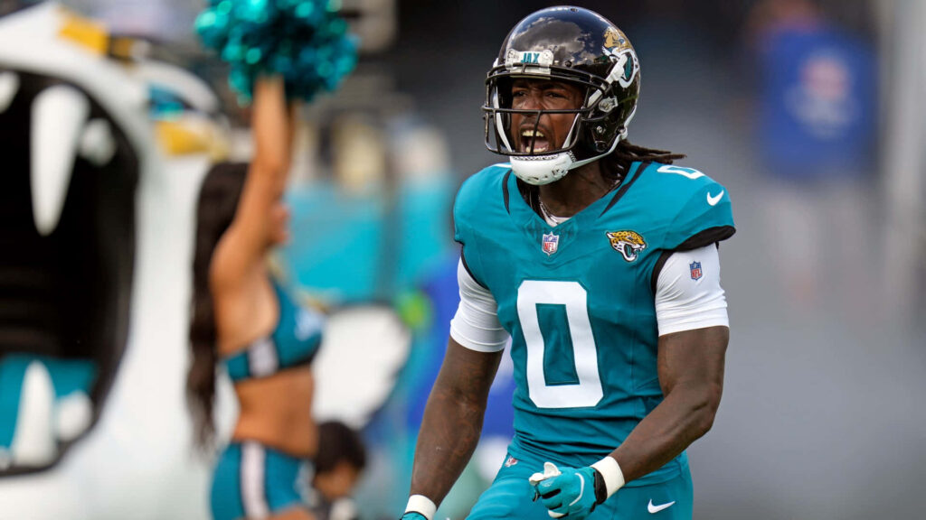 Calvin Ridley in Jacksonville Jaguars teal uniform with intense game focus on football field Wallpaper
