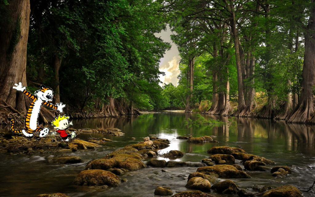 Calvin and Hobbes leap on rocks in a peaceful forest river with lush trees and sunlight Wallpaper