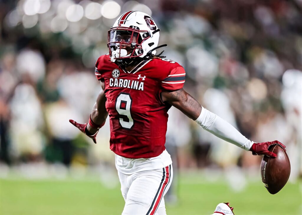 Cam Smith in red Carolina jersey number 9 intense football action dynamic athletic pose wallpaper
