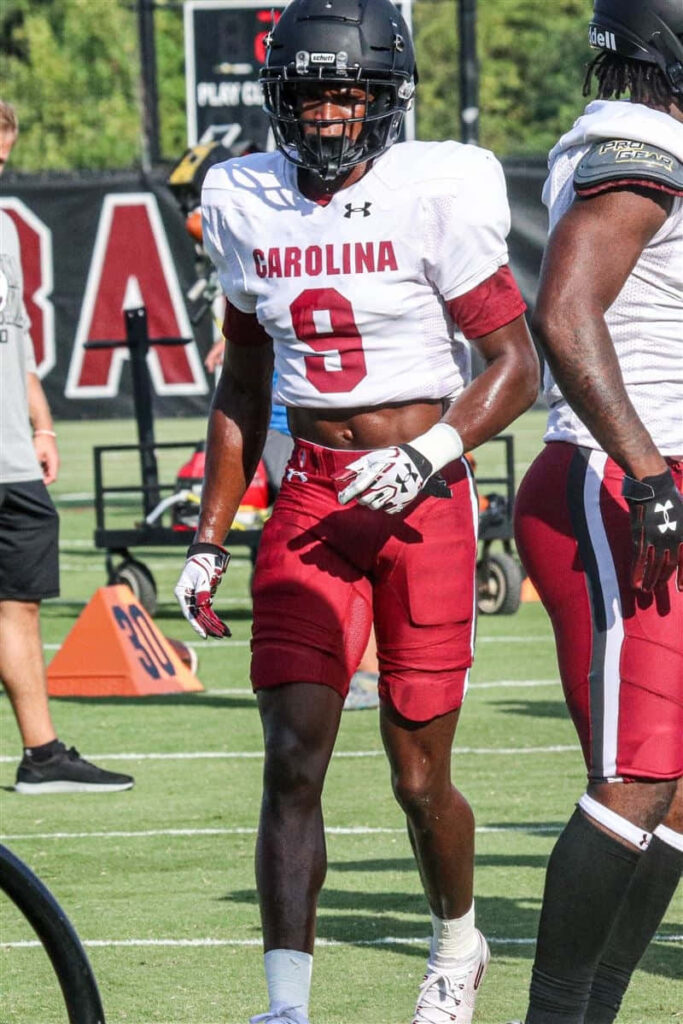 Cam Smith Carolina football player number 9 on vibrant practice field in garnet black uniform Wallpaper