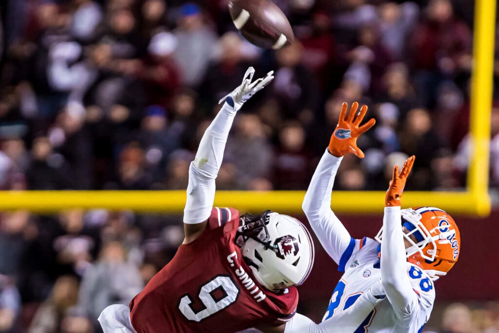 Cam Smith leaping to block a pass defensive skills intense football match wallpaper background