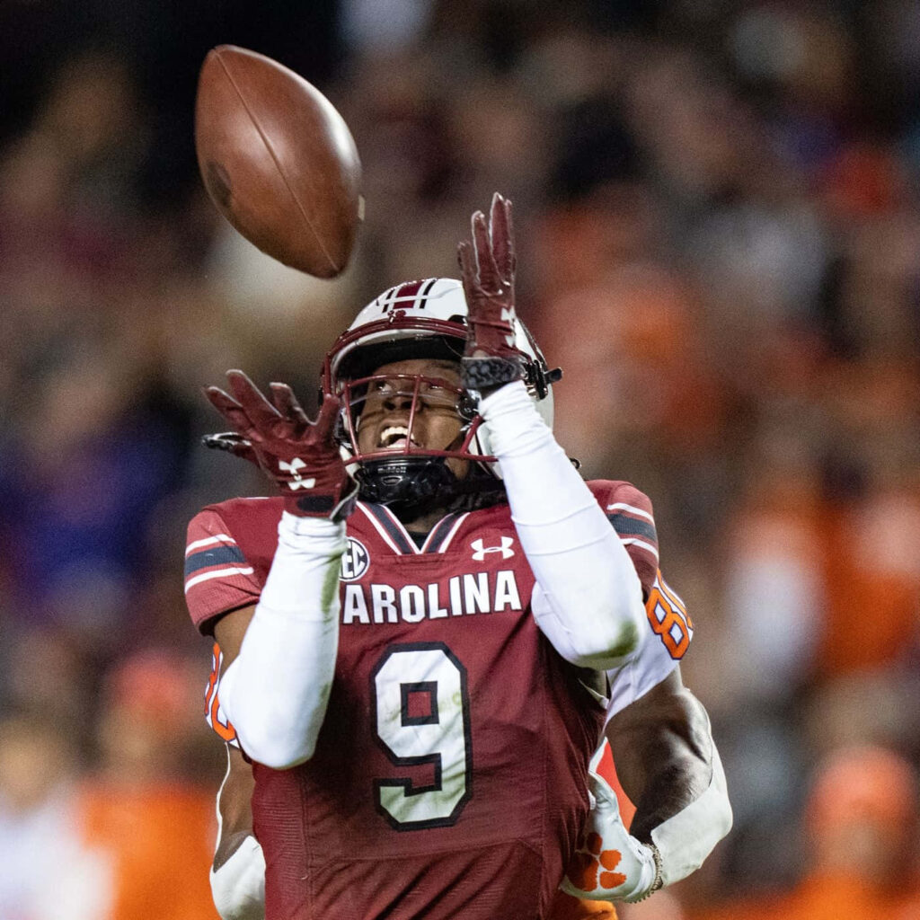 Cam Smith intense football action South Carolina maroon white uniform stadium crowd background Wallpaper