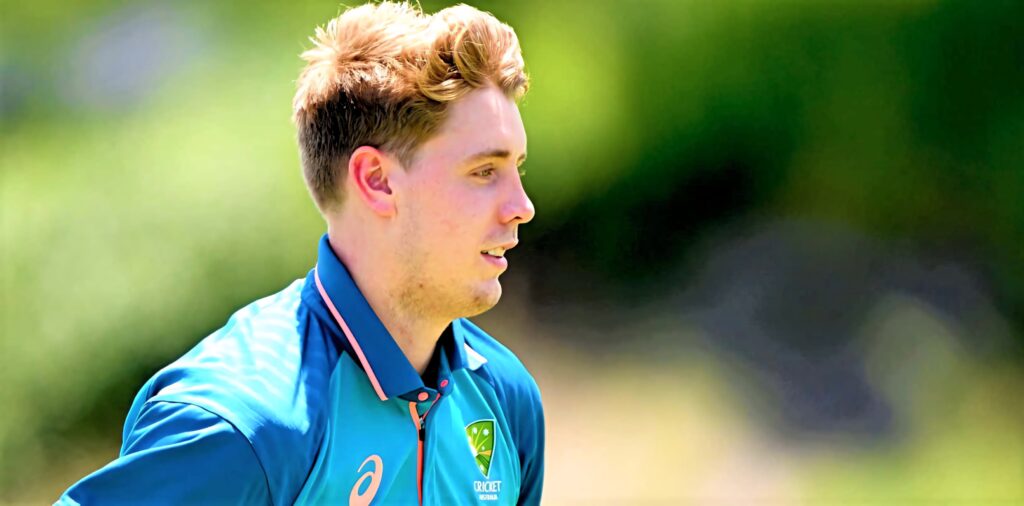 Cameron Green in bright Australian cricket jersey focused with lush green background and sharp detail Wallpaper