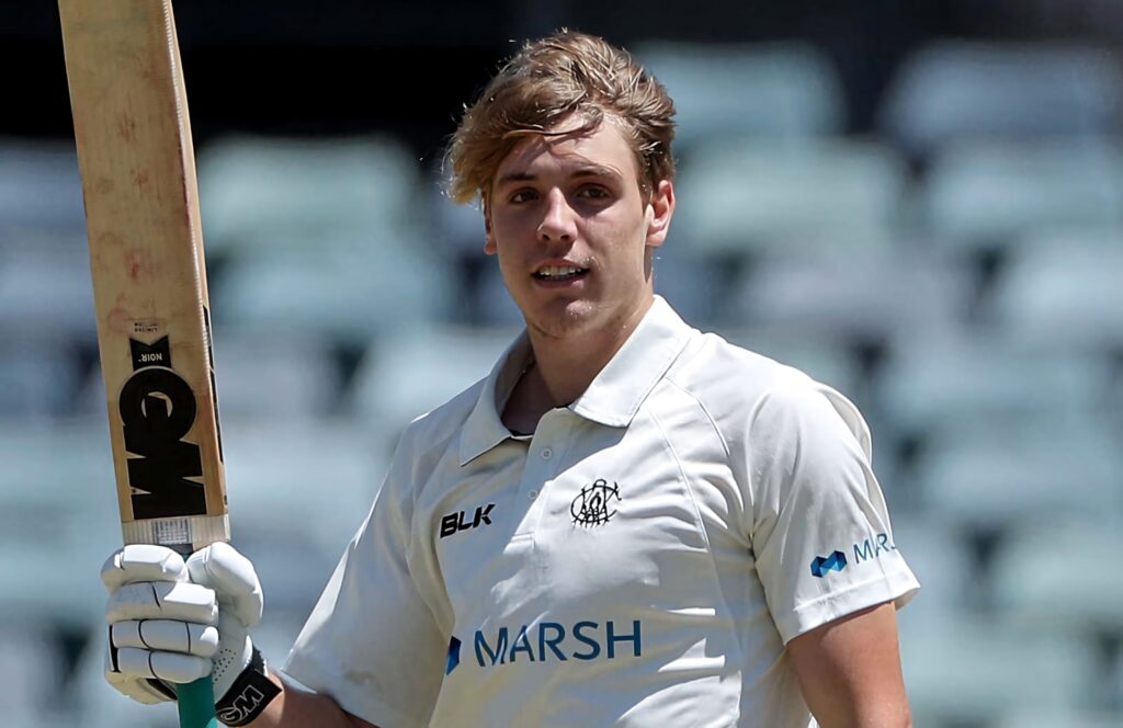 Cameron Green Australian cricketer in white uniform batting focused in stadium natural light Wallpaper