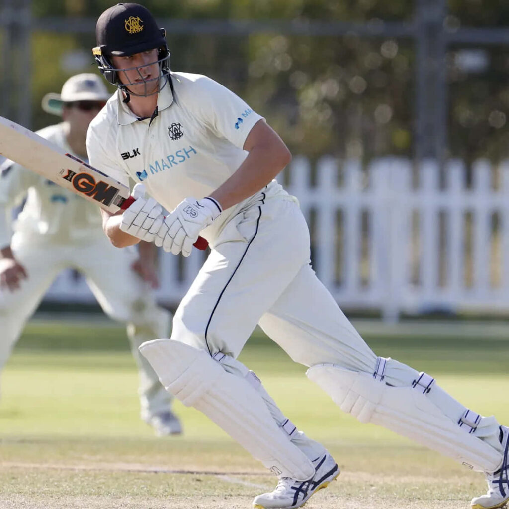 Cameron Green batting in white cricket gear outdoors showing focus and dynamic movement Wallpaper