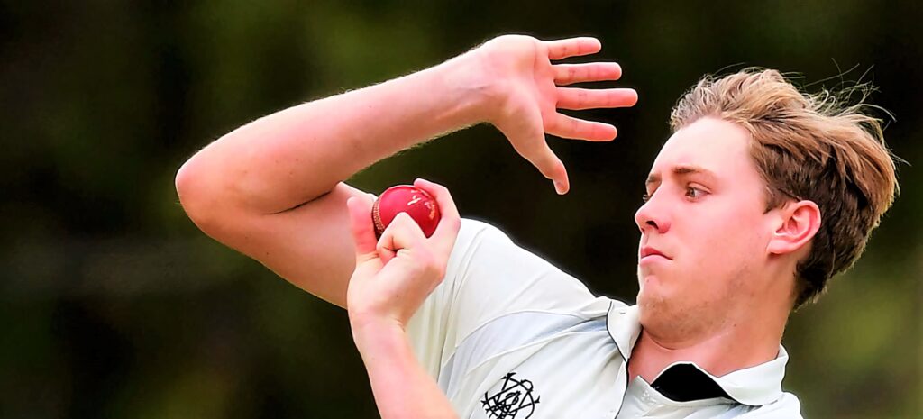 Cameron Green bowling cricket ball in white kit intense focus dynamic sports action wallpaper