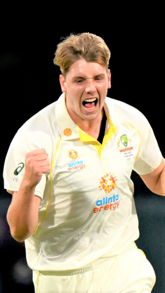 Cameron Green celebrates passionately in Australia Test cricket jersey on dark background wallpaperr