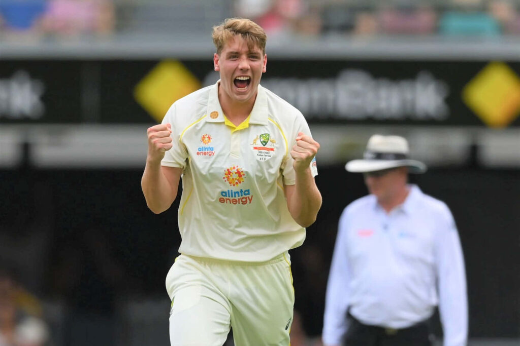 Cameron Green celebrates passionately in Australian Test cricket jersey on vibrant stadium field Wallpaper
