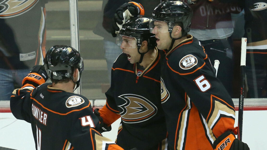 Cameron Matthew Fowler and Anaheim Ducks teammates celebrate on ice showing team spirit and excitement Wallpaper