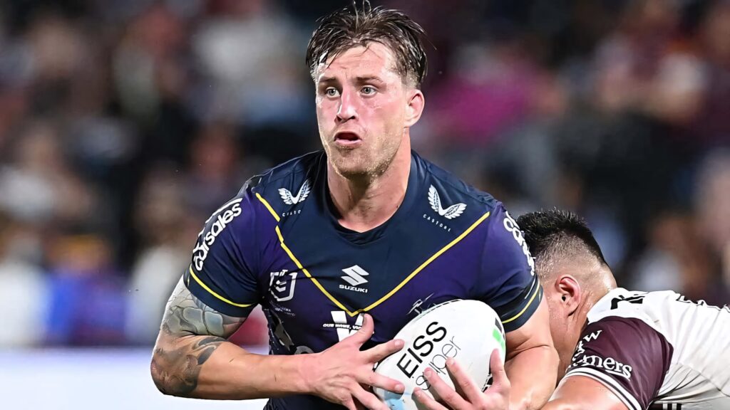 Cameron Munster Melbourne Storm rugby league star in action intense game vivid team colors wallpaper