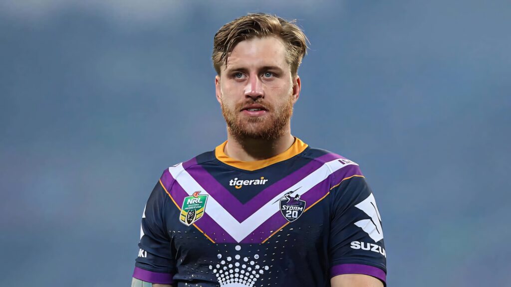 Cameron Munster Melbourne Storm rugby league player in purple kit with focused expression wallpaper