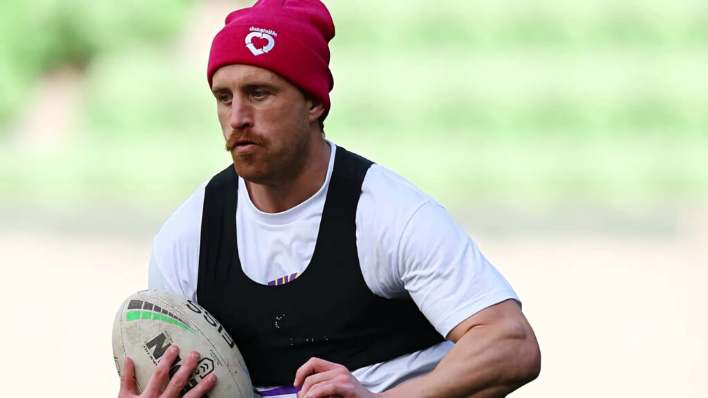 Cameron Munster rugby league player in red beanie holding ball during focused training session wallpaper