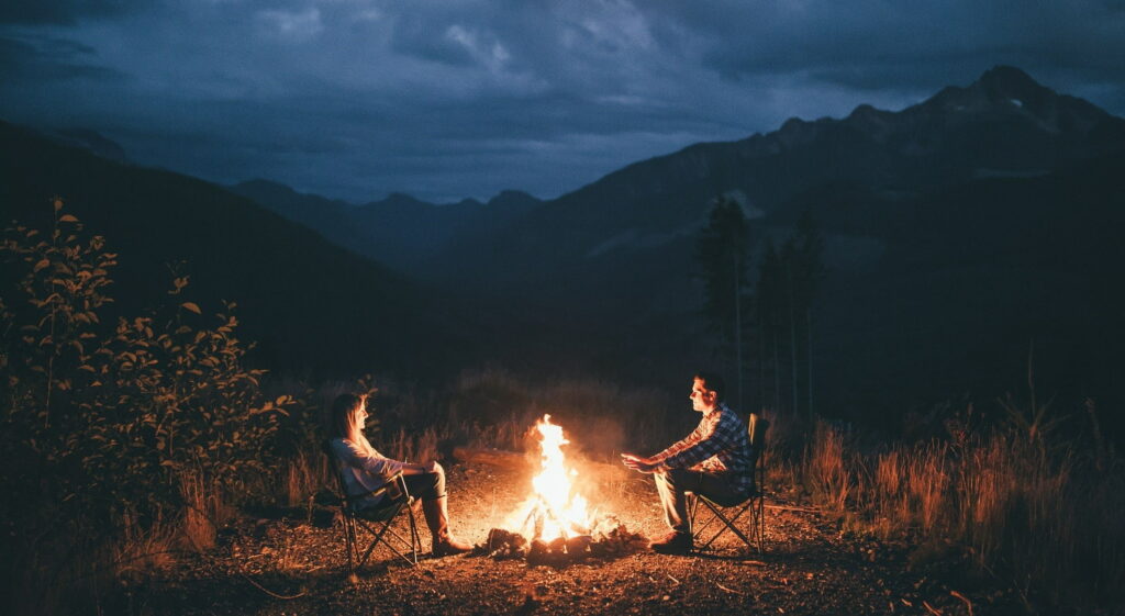 Glowing Campfire in Serene Landscape: A Camping Vibes HD Wallpaper Background