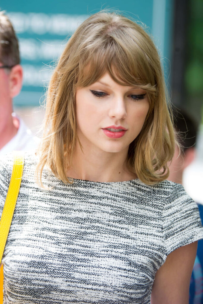 Candid Taylor Swift iPhone wallpaper showing natural stylish singer perfect for fans device
