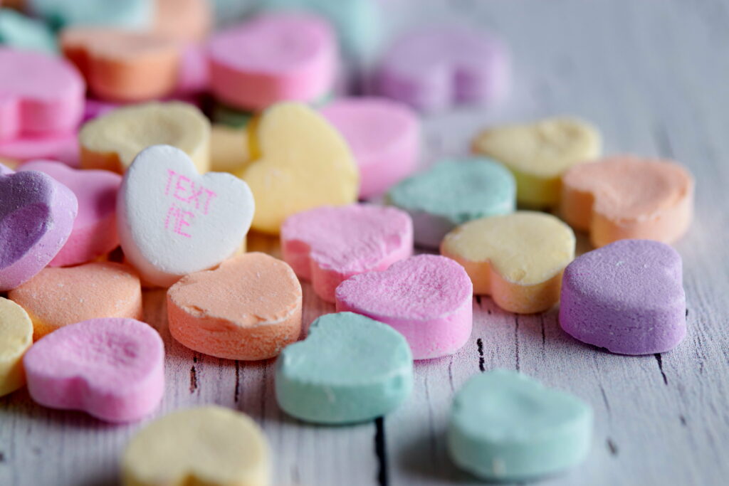 Sugar-Coated Hearts: An Enchanting Macro View of Colorful Candy Inscriptions in a Vibrant 4K Wallpaper