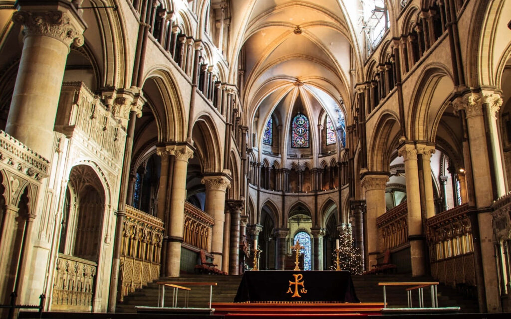 Canterbury Cathedral altar with Gothic arches stained glass and detailed stone carvings wallpaper