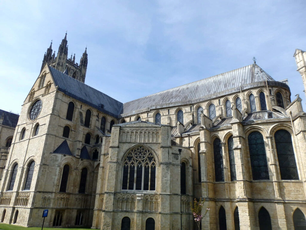 Canterbury Cathedral back view Gothic architecture arched windows stonework grand spires daylight Wallpaper