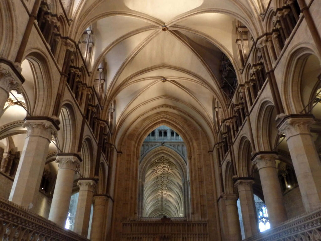 Canterbury Cathedral ceiling with intricate vaulted arches Gothic architecture warm stone hues Wallpaper