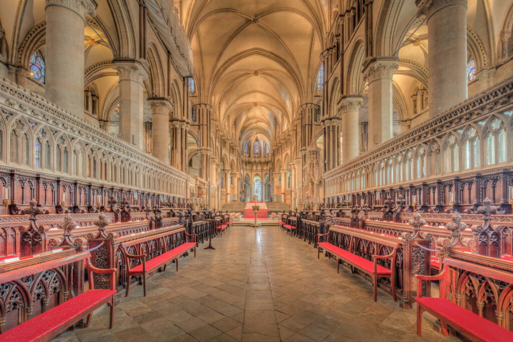 Canterbury Cathedral Quire with vaulted ceilings ornate Gothic woodwork and red choir stalls wallpaper