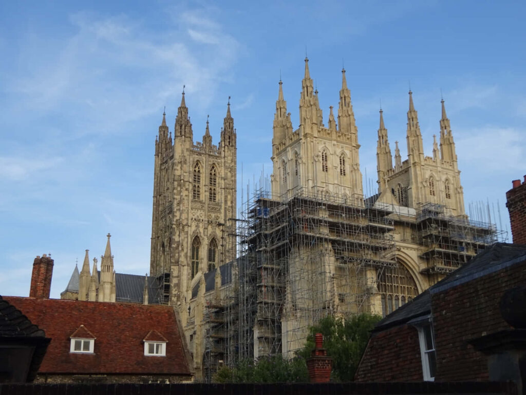 Canterbury Cathedral Gothic spires during renovation with scaffolding and blue sky background Wallpaper