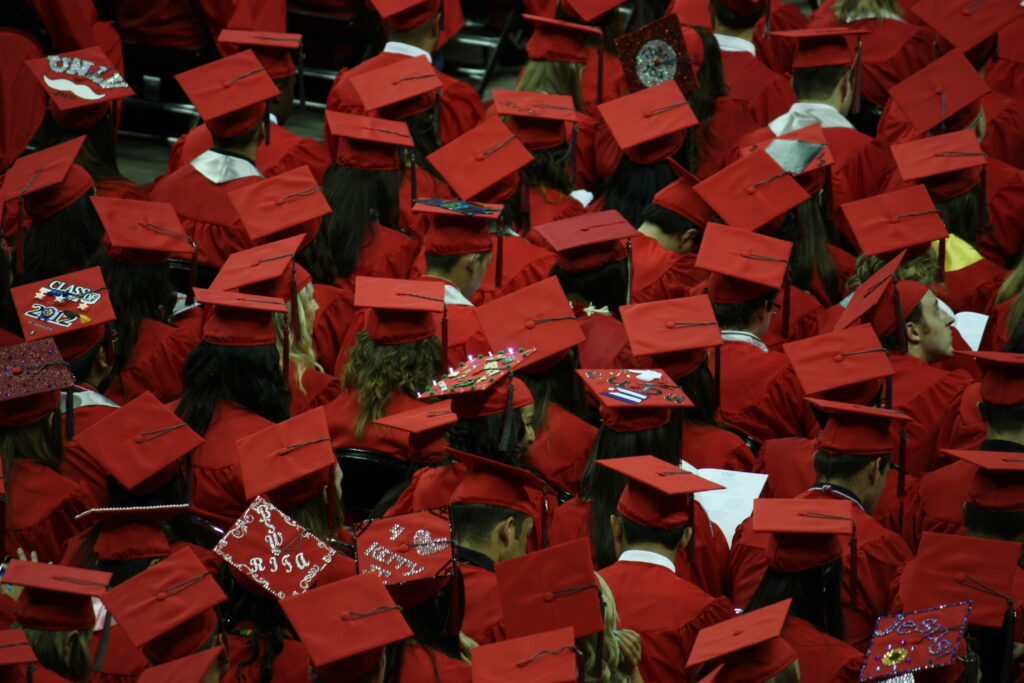 UNLV 2012 graduation ceremony with crimson caps gowns and decorated mortarboards high-angle view Wallpaper