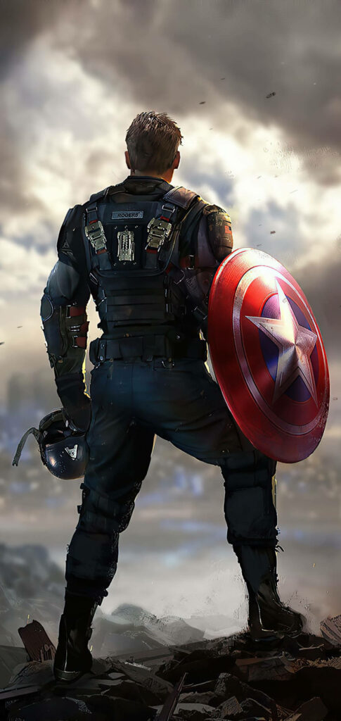 Captain America heroically stands with shield and helmet over battle-damaged landscape wallpaper