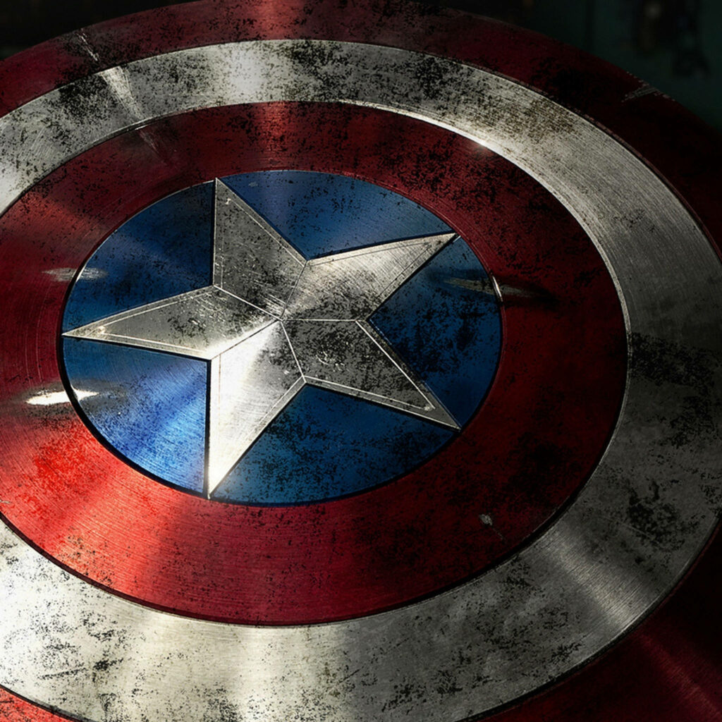 Shield of Justice: A Detailed Close-up of Captain America's Battle-Scarred iPhone Wallpaper