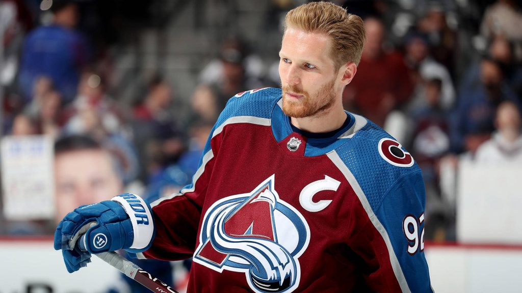 Captain Gabriel Landeskog in burgundy Avalanche jersey intense focus NHL game wallpaper background
