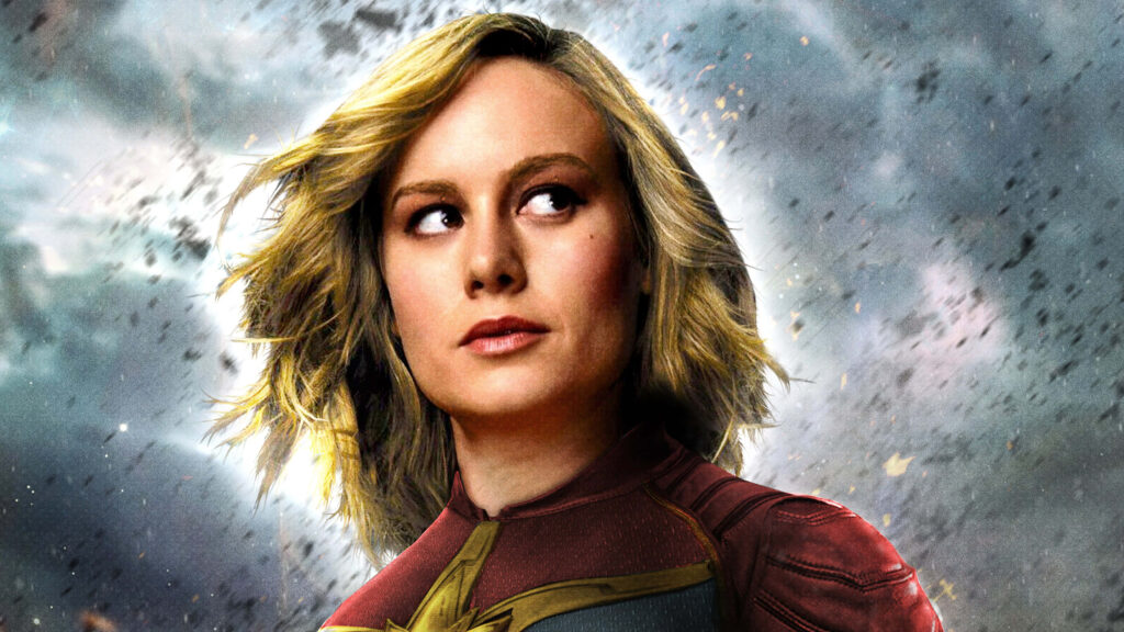 Captain Marvel portrait of Brie Larson in red gold suit with stormy sky cinematic lighting wallpaper