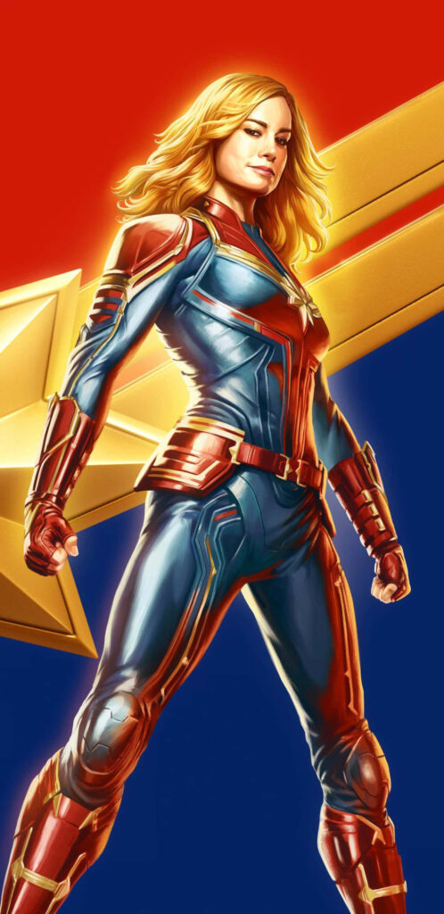 Joyful Captain Marvel: Carol's Radiant Smile Shines in Her Iconic Suit against a Marvelous Backdrop Wallpaper