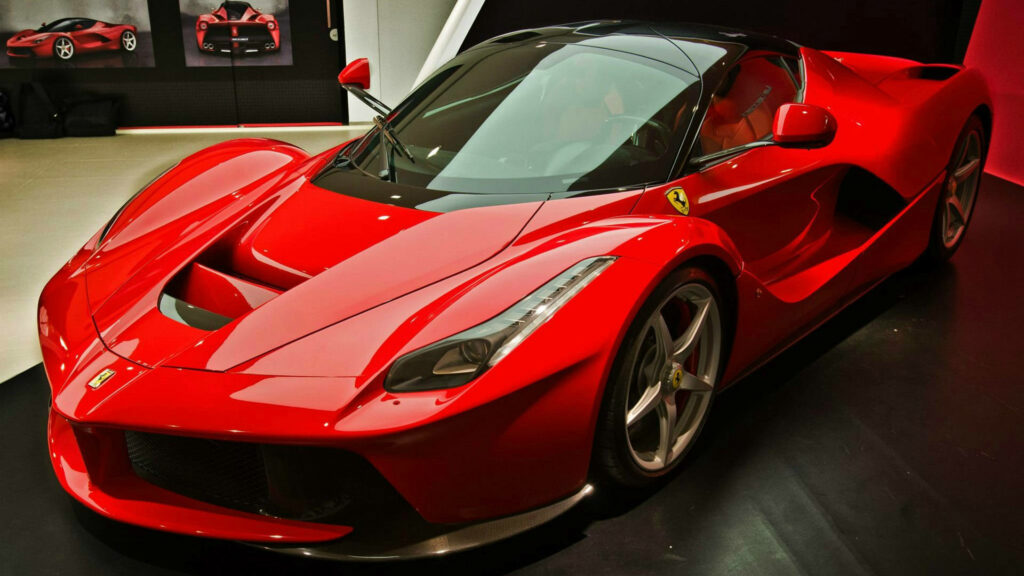 Exhilarating Speed: Showroom Display of a Radiant Red Ferrari LaFerrari Wallpaper