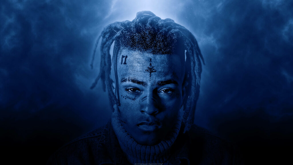 XXXTentacion portrait in deep blue filter digital art highlighting face tattoos and intense gaze Wallpaper