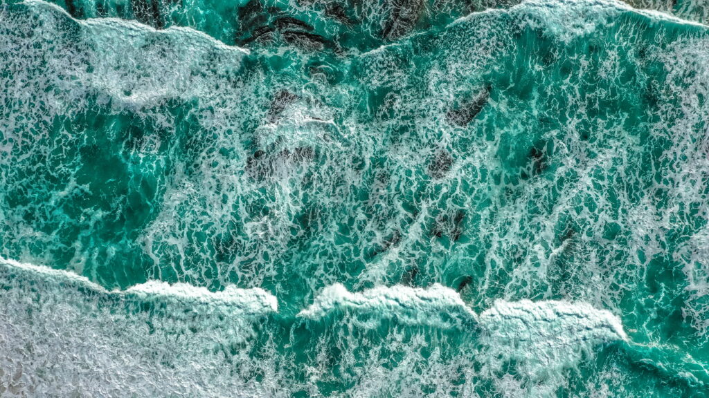 Ocean Symphony: A Majestic Aerial Capture of Serene Surf and Waves in a Mesmerizing 5K Wallpaper