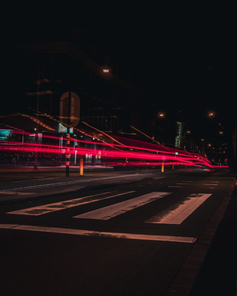 Mesmerizing Amsterdam Night Wallpaper with Red Light Trails