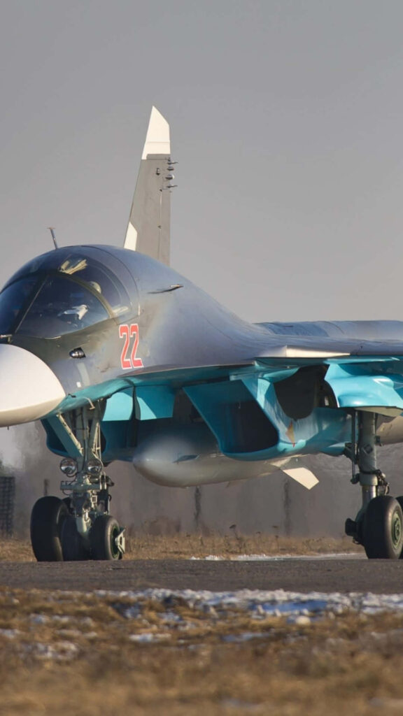 Majestic Sukhoi Su-34 Touches Down on Runway - Jumbo Jet Background Wallpaper