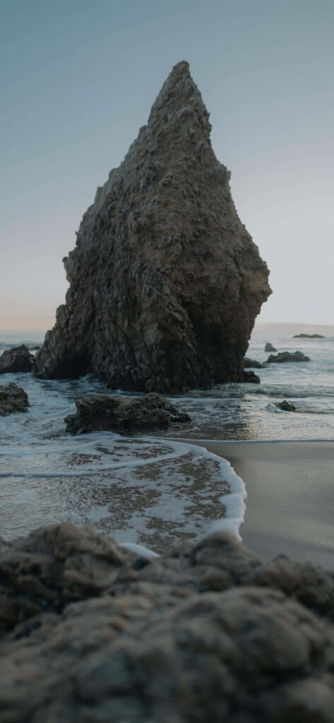 Majestic Rock Formation on the Tranquil Shores of El Matador State Beach: An Idyllic Malibu Wallpaper
