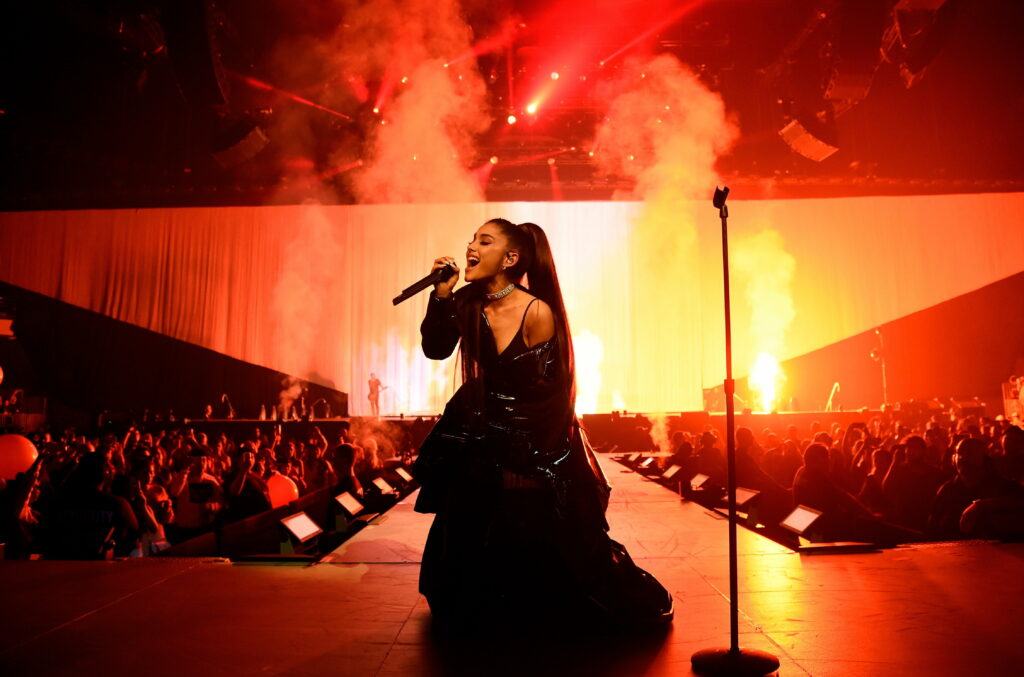 Fierce and Fabulous: Ariana Grande Mesmerizes the Crowd with her Electrifying Live Performance Wallpaper