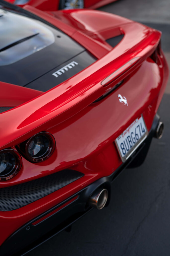 Red Ferrari Reveals Its Sleek Trunk in an Eye-catching Back-View Shot: Perfect Wallpaper Option