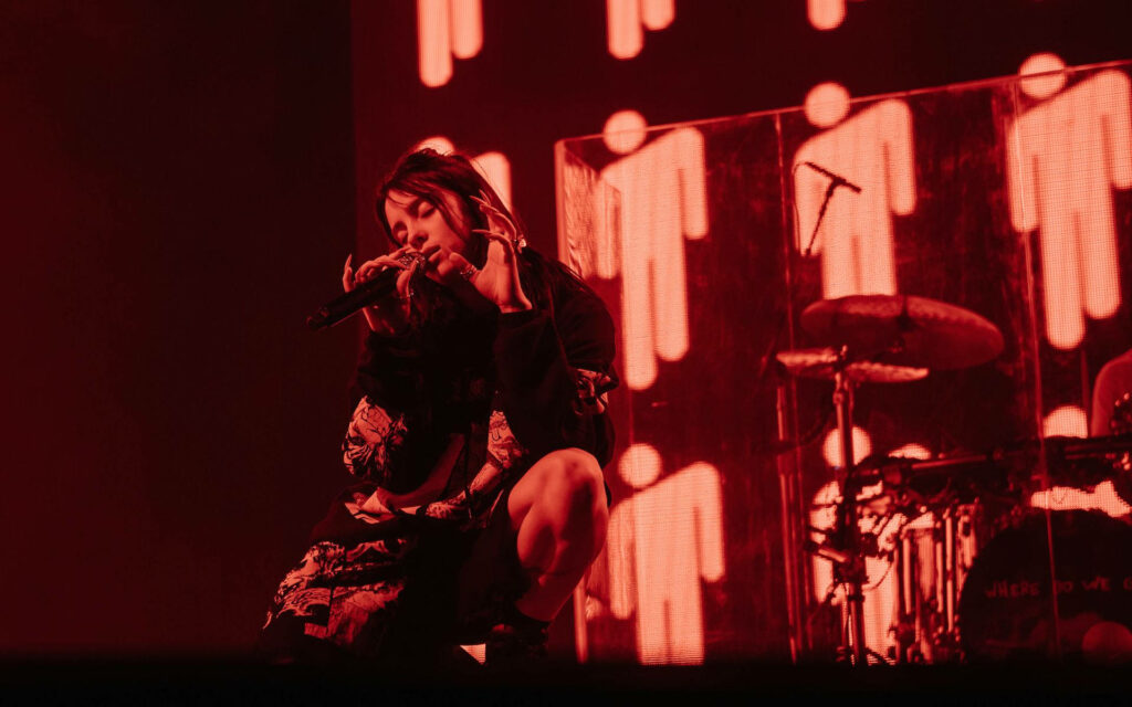 Captivating Red Aesthetic Wallpaper of Billie Eilish Live Performance